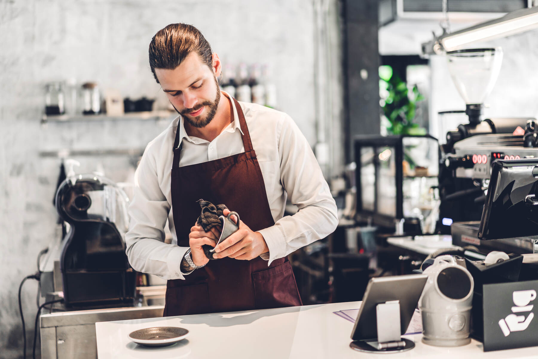Barista preparing coffee in a modern sleek coffee shop